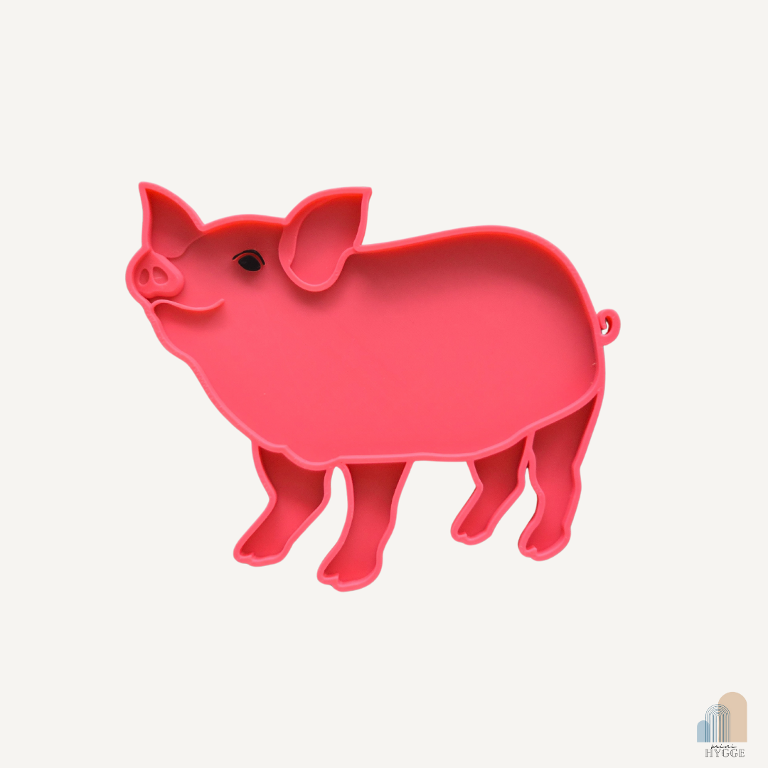Educatief sensorisch dienblad in de vorm van een roze varken, perfect voor thematisch spel.